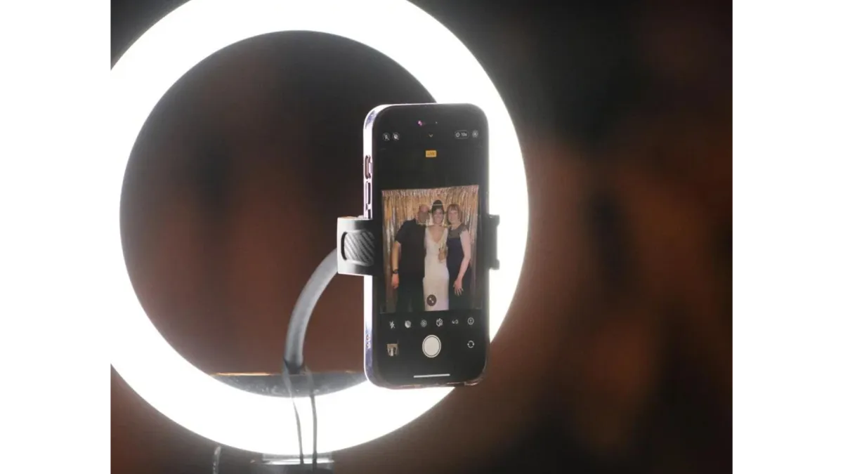 DIY photo booth setup at a wedding with a ring light and smartphone, showcasing creative alternatives to traditional wedding photographers.