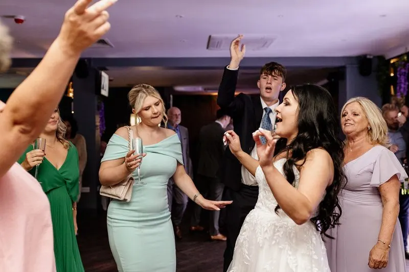 Bride dancing with wedding guests at the reception